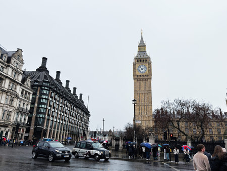 London, UK - February 01, 2026: Rainy day scene of people with umbrellas, cars and the iconic Big...