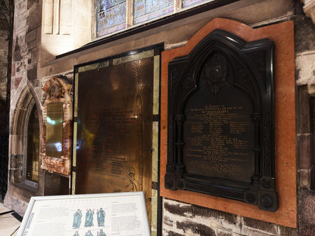 Edinburgh, Scotland, UK - February 15, 2026: Historic St Giles church interior with memorial plaques, brass panels, stained glass and carved stone conveying solemn remembrance.のeditorial素材