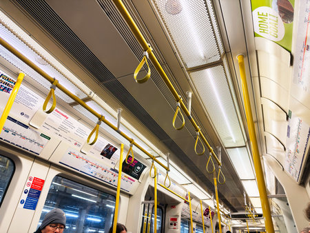 London, UK - February 02, 2026: Interior view of a London UK tube carriage showing commuters, yellow...