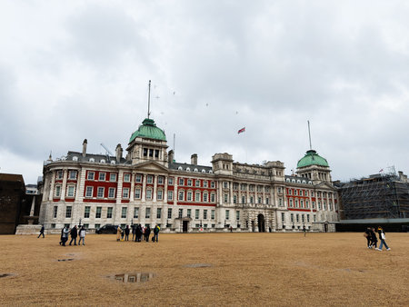 London, UK - February 02, 2026: Visitors stroll across a broad gravel courtyard in front of a grand historic government building in London, UK.のeditorial素材