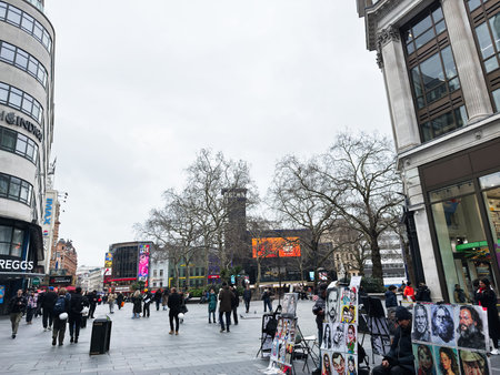 London, UK - February 02, 2026: Street vendors display painted portraits and tourists stroll across...