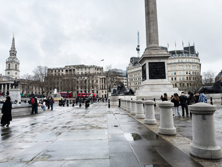 London, UK - February 02, 2026: Overcast day at Trafalgar Square in London UK featuring Nelson's Column, lion statues, fountains and tourists.のeditorial素材