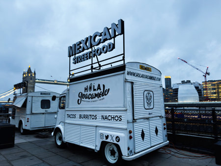London, UK - February 02, 2026: White Mexican food truck parked near Tower Bridge in London serving...