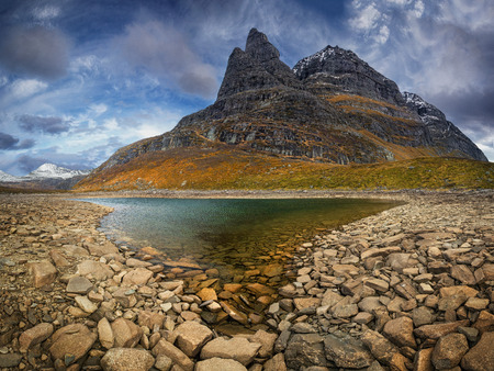 View on the Innerdalstarnet mountain from the Flatvaddalen valley. Mountains in Trollheimen national...