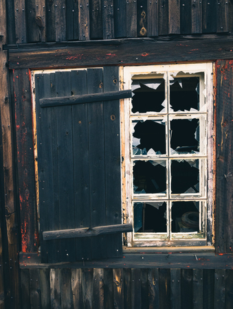 Wooden architecture, window motive. Old wooden house. Dark old planks. Wall surface.の写真素材