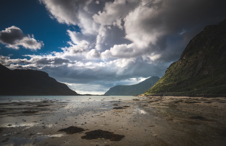 Amazing shores of Flakstadpollen sea bay on Lofoten, Norway. View on the mountains around. Summer trip.の写真素材