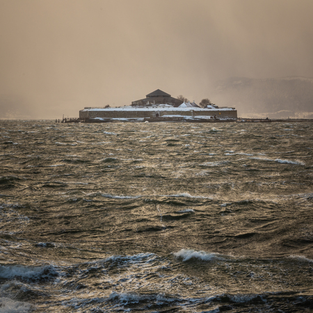 View on Munkholmen island with old monastery, later fortress. Winter blizzard, hail storm, stormy sea waters on Trondheimsfjorden.の写真素材