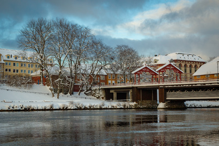 Old bridge called Gamle Bybro connecting old town Baklandet  with city center. Trondheim in Norway, beautiful winter scenery.の写真素材