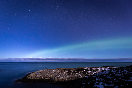 North lights Aurora Borealis seen from Atlantic Ocean Road - Atlanterhavsveien in winter night. Norwegian wintertime. Nice starry sky and green lights.の写真素材