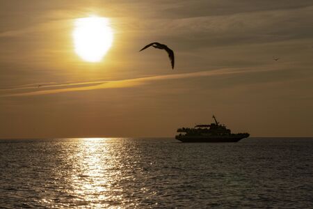 A tourist sunset cruise on a boat around Cape May Point NJの写真素材