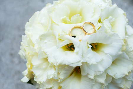Wedding rings with petals can be used on invitation card or wedding decorationの写真素材