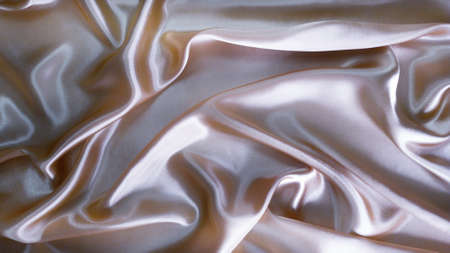 Beautiful silver textured background made of silk fabricの写真素材