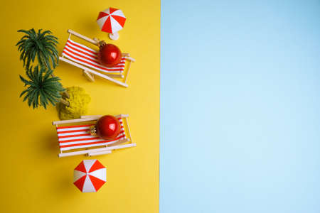 Creative New Year photo Christmas balls resting on the beachの写真素材