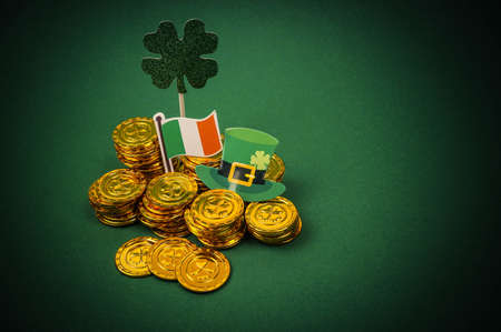 Saint Patrick's Day background with gold coins and flag of Ireland.