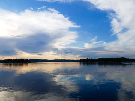 Sunset on the background of the riverの写真素材