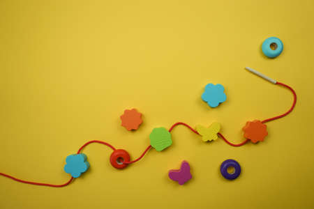 wooden beads for child development on a yellow backgroundの写真素材