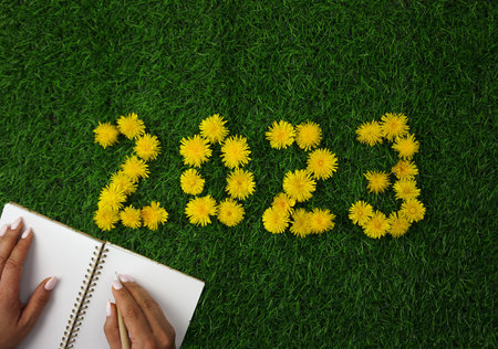 The numbers 2023 are laid out on the green lawn