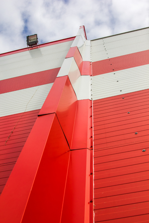 Made of red and white sandwich panels. Visible structure of the seam between the panels.の写真素材
