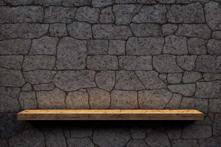 Empty wood shelf on stone wall texture background. For product display.の素材