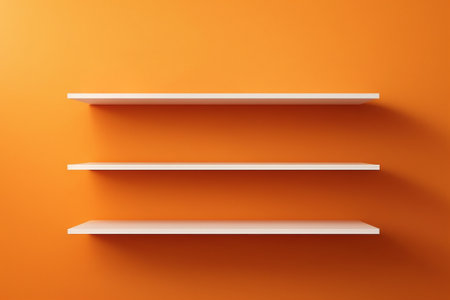 White bookshelves on orange wall. 3d render illustration.の素材