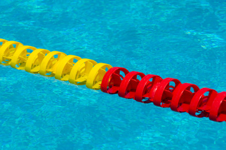 Swimming pool water surface detail with floaters.の写真素材