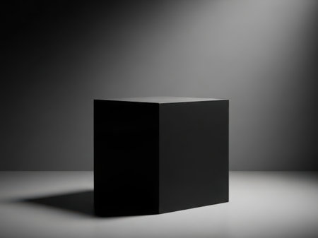 A simple black book lies open on a plain white surface against a dark background, creating a stark contrast and minimalist aesthetic.の素材