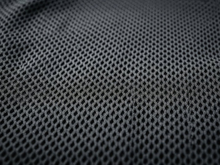 Close-up of dark gray mesh fabric with hexagonal patternの素材