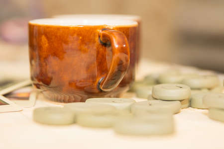 Two cups of tea and runes are on the tableの写真素材