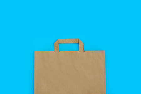 brown paper bag with handles on a blue background. top viewの写真素材