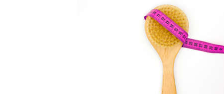 Spa organic brush for dry massage and a measure tape. Cactus brush. Anti-cellulite massage. Home Spa beauty concept. Banner. White background. space for text.の写真素材