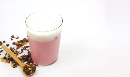 Pink Moon Milk for a better sleep, midnight relaxing drink. Immunity, beverage. A glass next to the...