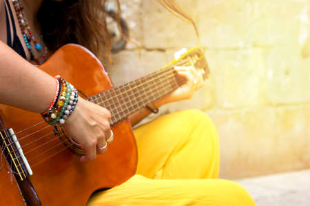 Woman hand playing acoustic guitar, close up on musical instrument Relaxation Music sound hobby...