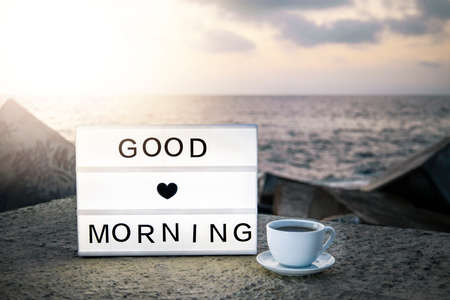 Good morning concept. lightbox next to a cup of tea or coffee in the morning. Inspiration...