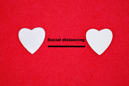 Top view two white hearts shape on red background. Social distance concept, valentines day and love. Stay safe concept. Online datingの写真素材