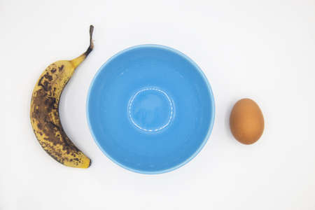 Step 1. Ingredients ripe banana and egg. Cooking banana pancakes without flour tutorial. Step by step recipe. Top view white background. Gluten free breakfast.の写真素材