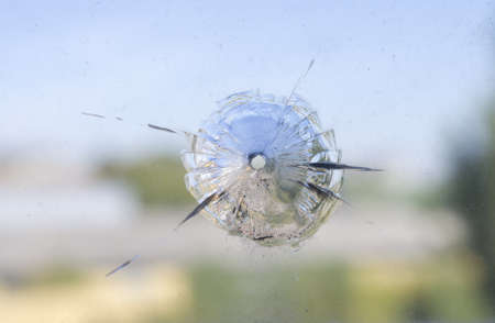 The round hole, is probable from shot, in old dirty glassの写真素材