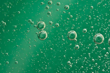 Macro Oxygen bubbles in water on a green background,  concept such as ecology and other your...