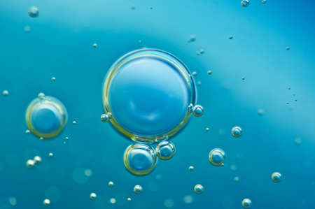 Macro Oxygen bubbles in water on a blue background, concept such as ecology and other your successful projectsの写真素材