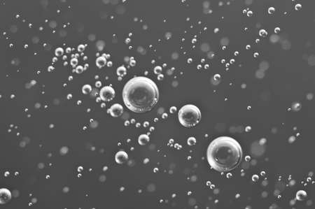 Macro Oxygen bubbles in water on black-and-white background, concept such as ecology and other your...
