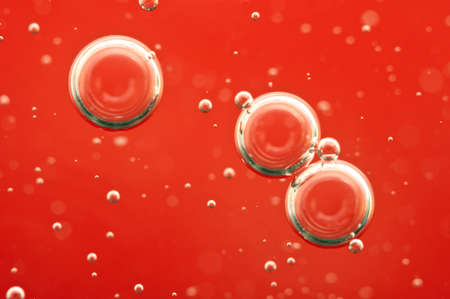 Air bubbles in a red liquid , concept such as medical research of blood and other your successful projects. Macroの写真素材