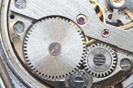 Metal cogwheels inside clockwork. Concept Eternity, Teamwork , Idea Technology. Macro.