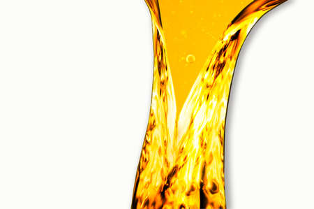 Liquid flows yellow, for the project, oil, honey, beer or other variants on white backgroundの写真素材