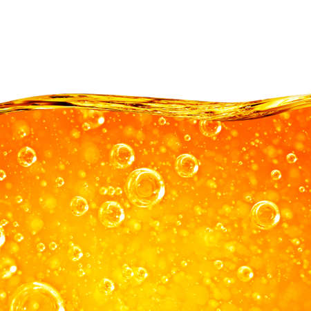 Liquid flows orange wave, for the project, oil, honey, beer, juice or other variants, area for text on white backgroundの写真素材