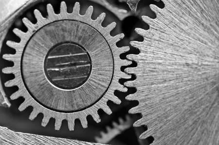 Macro. Black and white background with metal cogwheels close-up clockwork. Conceptual photo for your successful business design or other successful variantsの写真素材