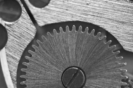Macro. Black and white background with metal cogwheels close-up clockwork. Conceptual photo for your...