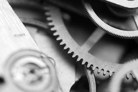 Black and white Background with metal cogwheels clockwork. Concept Teamwork. Macro.