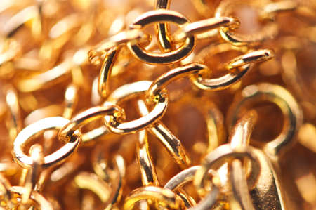 Golden chain links  close-up full screen. Golden background. Conceptual photo. Macro.の写真素材