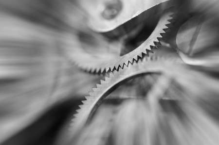 Black and white photography. Metal Cogwheels in clock mechanism , abstract sun beams, Concept Movement is life, Teamwork , Idea Technology, Infinity, Time. Macro.の写真素材