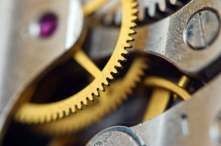 Cog wheels. Yellow gears, clockwork. The concept of time, teamwork, successの写真素材