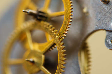 Cog wheels. Yellow gears, clockwork. The concept of time, teamwork, successの写真素材